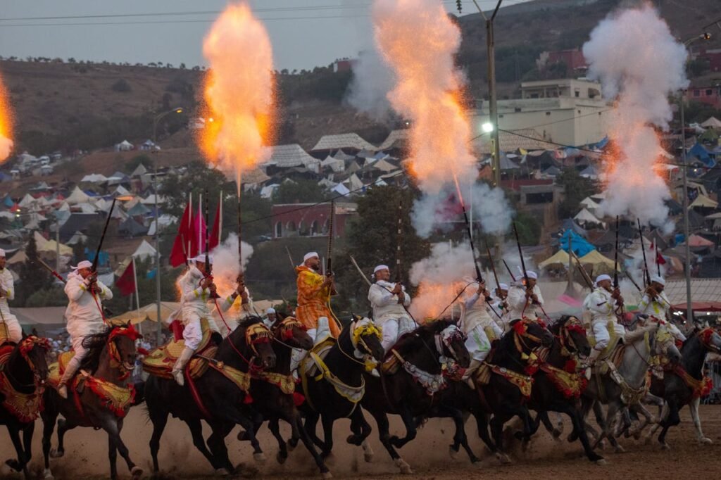 A group of Moroccan horsemen perform a Tbourida display with smoke and fire in Sidi Moussa El Mejdoub.