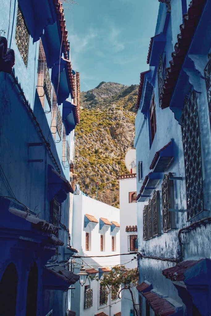 Discover the stunning blue-washed streets of Chefchaouen with mountain views, a photographer's paradise.